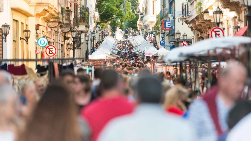 San Telmo Fair in Buenos Aires with people walking through stalls among colonial buildings