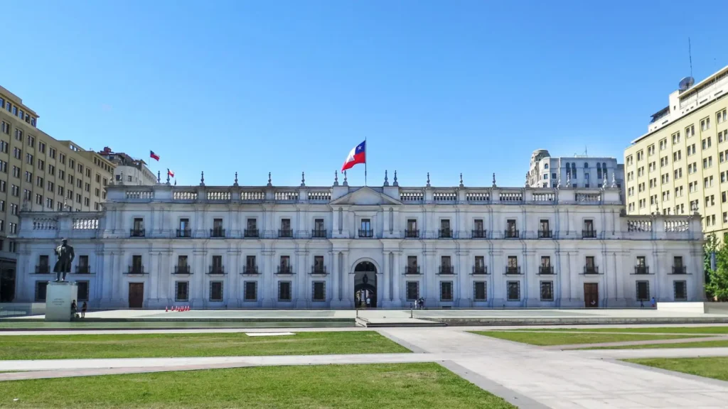 Facade of the Palacio de La Moneda with the Chilean flag waving, in Santiago de Chile