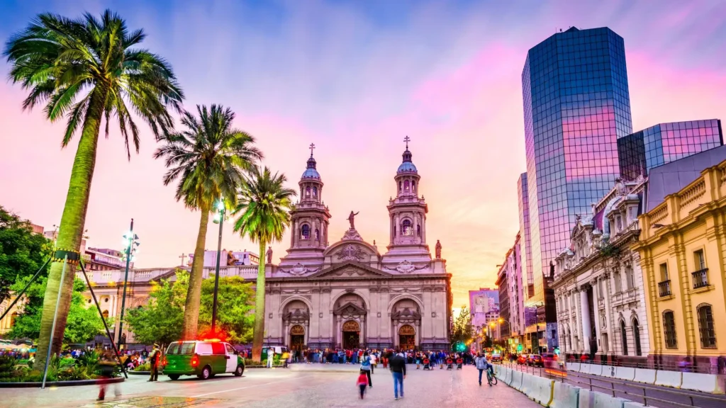 Metropolitan Cathedral of Santiago and palm trees in Plaza de Armas at sunset, in Santiago de Chile